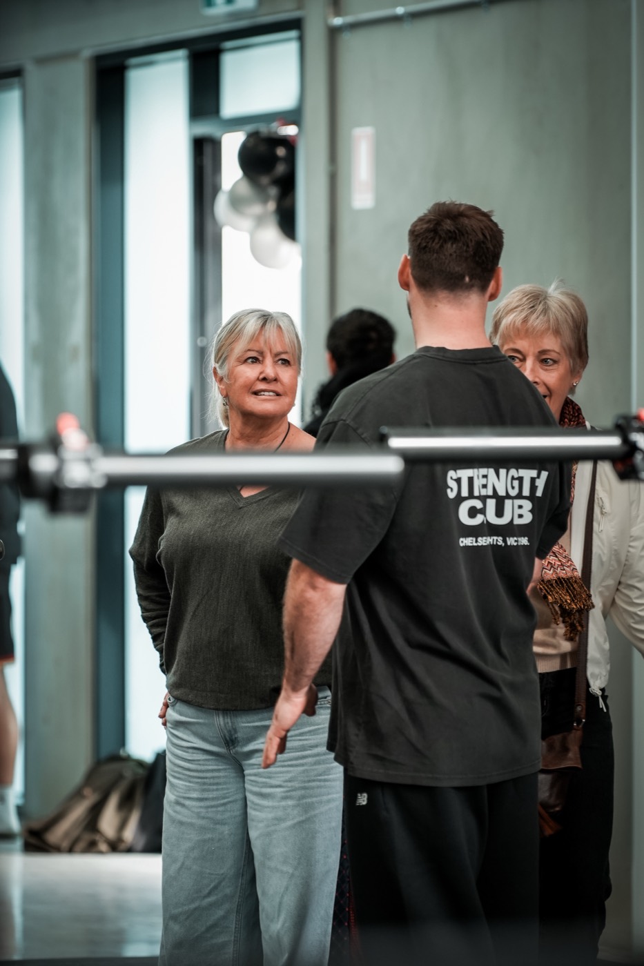 RTB coach adjusting a member's grip on the bar